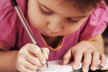 little baby girl learns to write (development,  education concept)