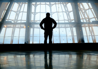Obraz na płótnie Canvas Silhouette of man standing over window