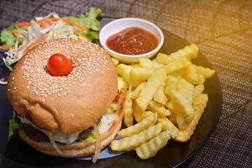 Hamburger with salad potato fired , light effect.