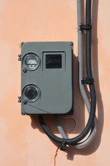 Electric power meter outdoor. House Watt hour Electric meter measurement on house wall. Electrical wiring. Electric wire installation in house.