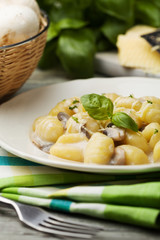 Portion of gnocchi with mushroom sauce and cheese.