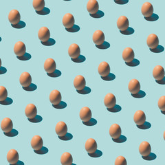Pattern made of eggs on pastel blue background. Minimal food concept.