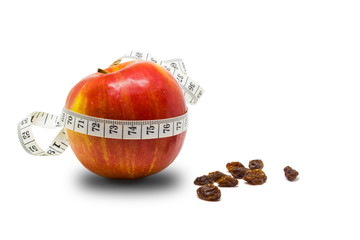 Red apple with measuring tape and raisins. Healthy food concept, the concept of a healthy lifestyle, the concept of weight loss.