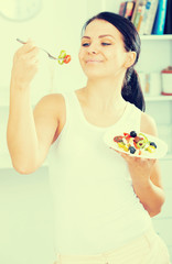 Woman holding fork and plate