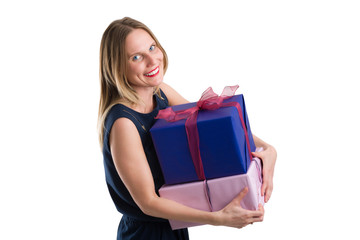Attractive woman carrying big gift packages, isolated on white