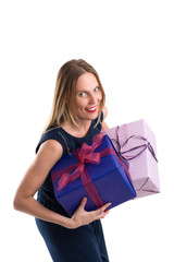 Attractive woman carrying big gift packages, isolated on white