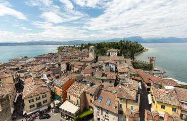 Fototapeta na wymiar View of colorful old buildings in Sirmione and Lake Garda from Scaliger castle wall, Italy