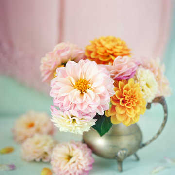Beautiful bouquet of a yellow and pink dahlias on a light green background.Lovely bunch of flowers .
