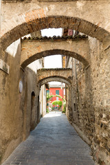 Fototapeta na wymiar Picturesque narrow town street in Sirmione, Lake Garda Italy.