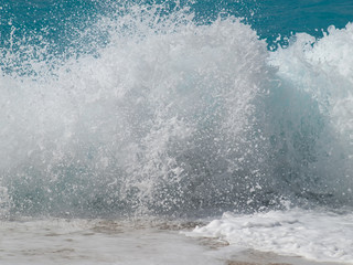 Sea foam. Big wave splashing and approaching the seashore. Lefkada, Ionian sea, Greece