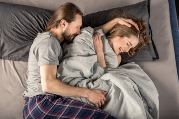 Fototapeta na wymiar Young couple in bed