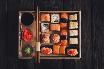 Set of sushi maki and rolls at black rustic wood. © Prostock-studio