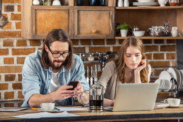 Couple using digital devices