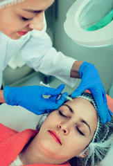 Fototapeta premium Female doctor doing beauty injection to young woman client