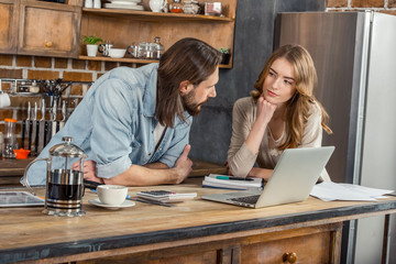 Couple using laptop