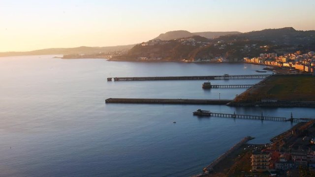 Sunset over the seaside with flare effect. Naples bay and the island of Nisida