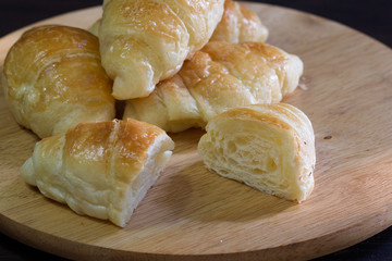 Croissant on chopping board on wooden table /Still life and selective focus image..