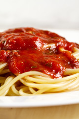Tasty colorful appetizing cooked spaghetti italian pasta with tomato sauce bolognese and fresh basil. Closeup.