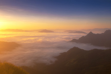 Dreamy sunrise on the top of the mountain with the view into misty valley. Beautiful day in nature.