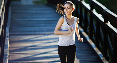 Sporty female jogger running and training outside