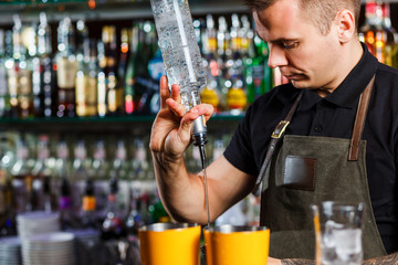 The bartender making cocktail