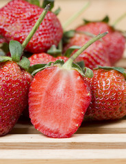 photo of delicious strawberries on wooden table background