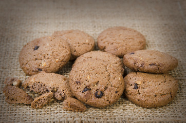 Stacked chocolate chip cookies on brown napkin