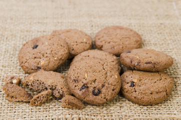 Stacked chocolate chip cookies on brown napkin