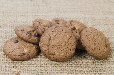 Stacked chocolate chip cookies on brown napkin