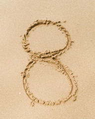 Number 8. Sand Alphabet: digits. Concept holiday background.