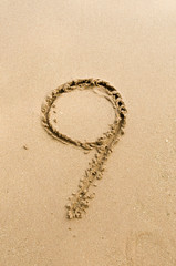 Number 9. Sand Alphabet: digits. Concept holiday background.