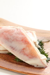 red fish frozen on wooden plate