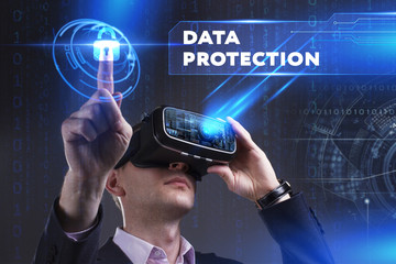 Business, Technology, Internet and network concept. Young businessman working in virtual reality glasses sees the inscription: Data protection