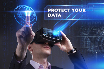 Business, Technology, Internet and network concept. Young businessman working in virtual reality glasses sees the inscription: Protect your data
