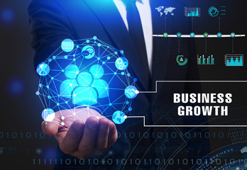 Business, Technology, Internet and network concept. Young businessman working on a virtual screen of the future and sees the inscription: Business growth