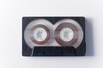 One black audio cassette on white background