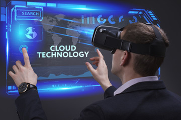 Business, Technology, Internet and network concept. Young businessman working on a virtual screen of the future and sees the inscription: Cloud technology