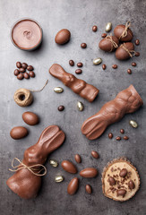 Chocolate Easter bunny and eggs on wooden background