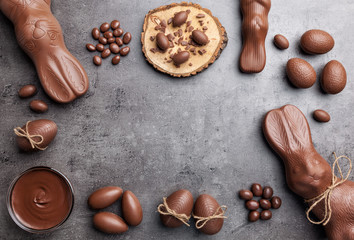 Chocolate Easter bunny and eggs on wooden background