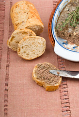 Slice of homemade bread with pate and herbs