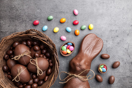 Chocolate Easter bunny and eggs on wooden background