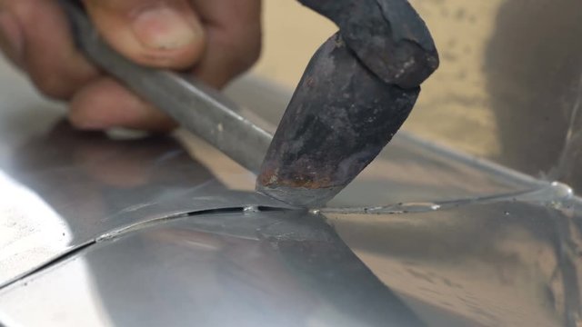 Detail of a roofer welding stainless gutter
