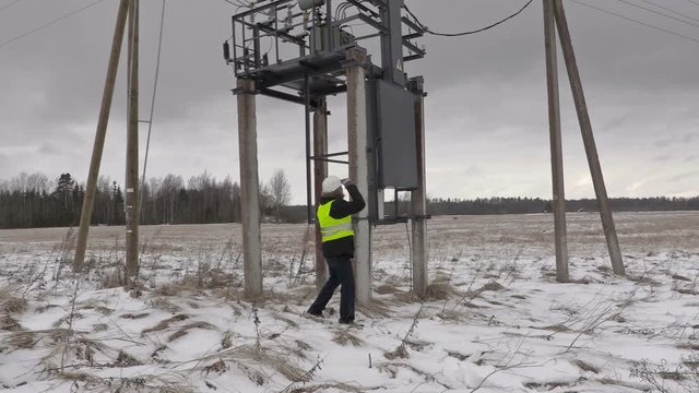 Electrician take pictures under  power lines