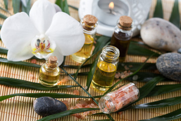 Obraz na płótnie Canvas Aroma oil for aromatherapy,orchid blossom,stone,Himalayan salt