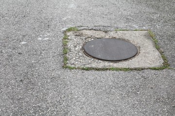 steel lid circle old  drain  on the road