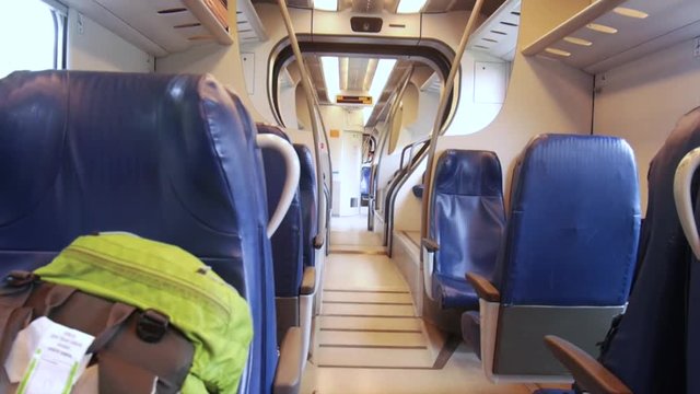 Fixed shot of a moving  local train from the inside, bag in the front