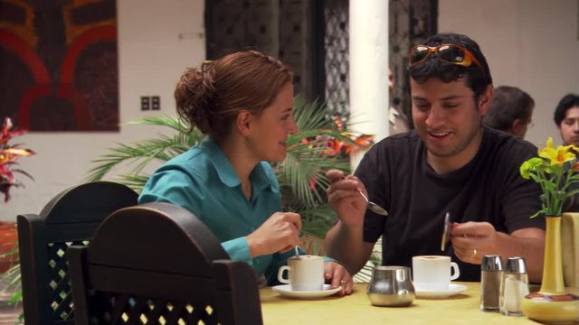Young couple drinking chocolate at a restaurant in Cuenca, Ecuador