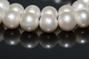 Pearl necklace on a dark background - 139938404