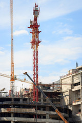 Fototapeta na wymiar Industrial construction cranes and building