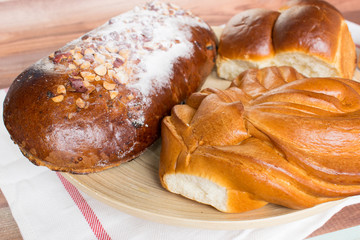 Fresh bread composition on the wooden background.